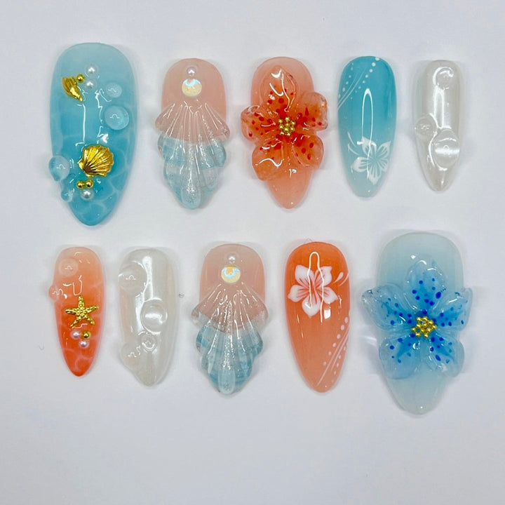 Handmade Tropical Ocean Press-On Nails – vibrant blue and coral tones with 3D seashells, flowers, starfish, and pearl accents. Perfect for  summer holidays, birthdays, vacations, or as a unique gift for her.