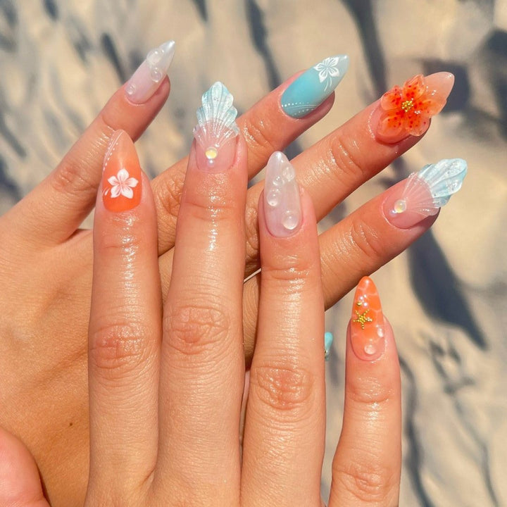 Handmade Tropical Ocean Press-On Nails – vibrant blue and coral tones with 3D seashells, flowers, starfish, and pearl accents. Perfect for  summer holidays, birthdays, vacations, or as a unique gift for her.