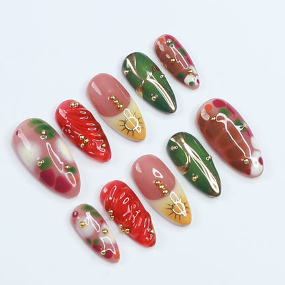 Handmade Press-On Nails with vibrant red, green, and gold designs, featuring intricate details and glossy finishes. Perfect for holidays, birthdays, vacations, or as a unique gift for her.