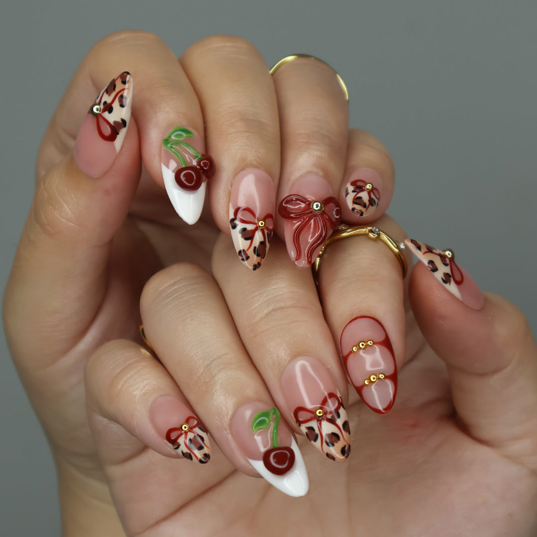 Sweet cherry Handmade Press-On Nails – playful and bold design with cherry motifs, leopard print accents, and 3D bows. Perfect for holidays, vacations, birthdays, valentine or as a stylish gift for her